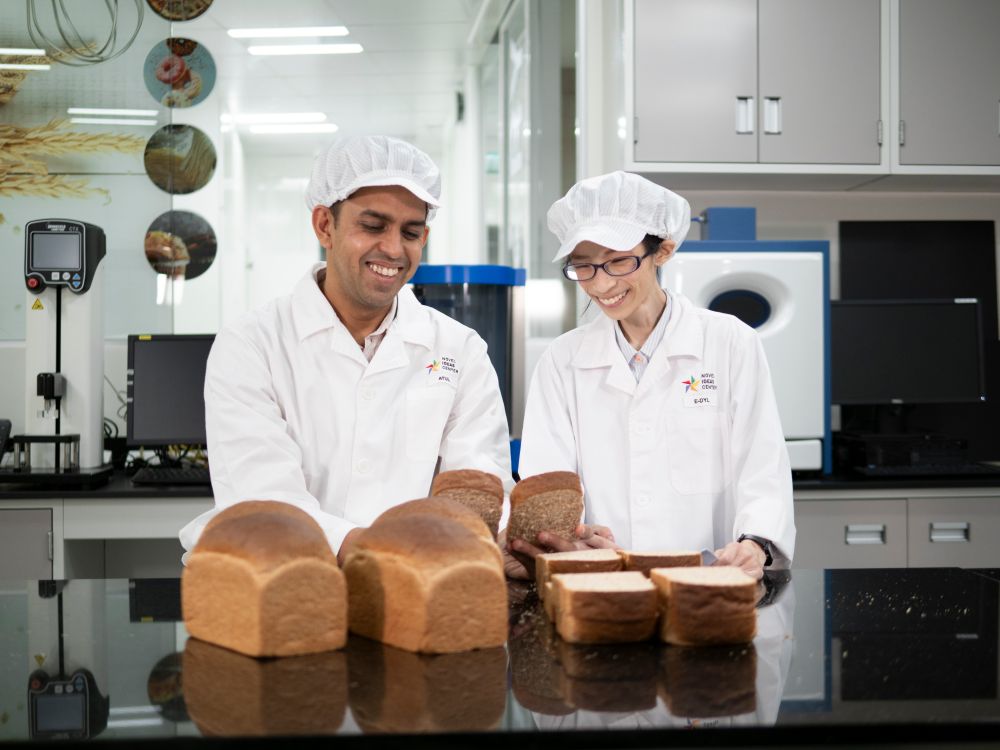 Atul Prakash, Manager of the Bakery and Asian Food department analysing the texture and quality of a trial bread sample with his food technologist